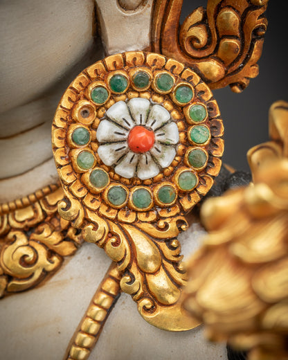 Close up of earrings with intricate gold-gilded details on Lokeshvara