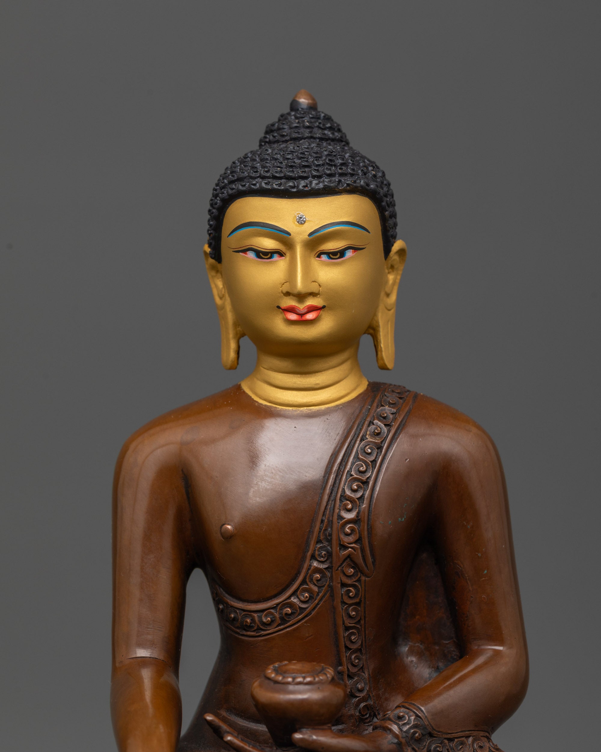 Close up of gold-gilded face of Shakyamuni Buddha with serene expression and halo