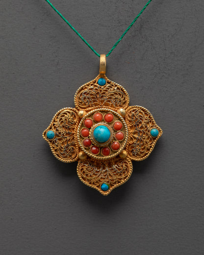 Close up of gold-plated lotus locket filigree design and turquoise center stone
