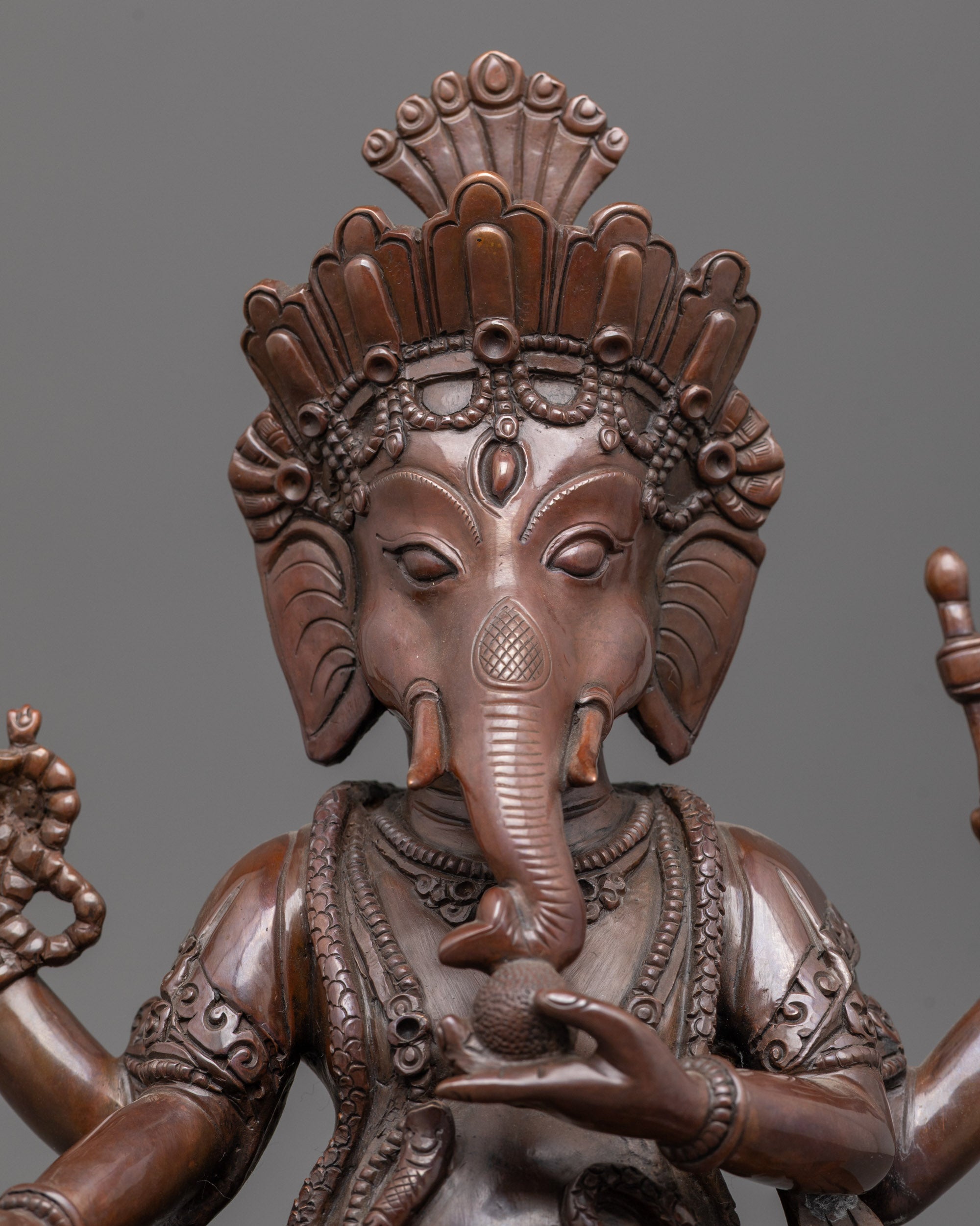 Close up of handcrafted oxidized copper Lord Ganesha idol highlighting intricate details.