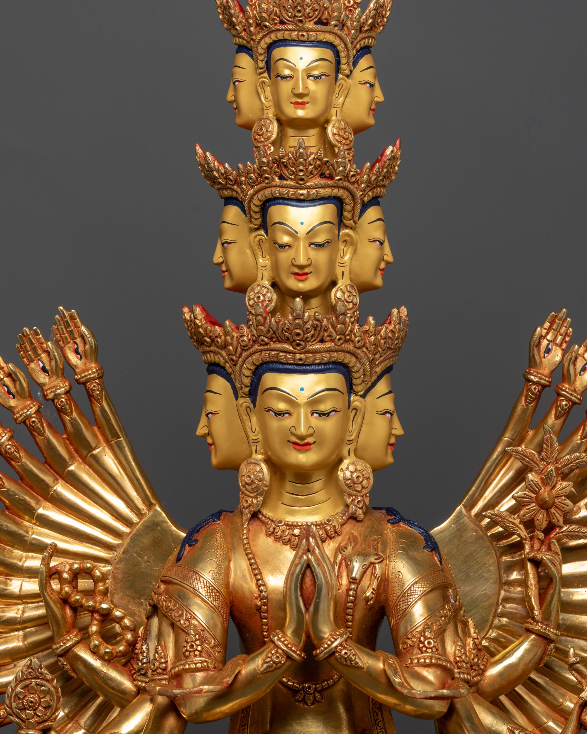 Close up of intricate arms and eleven crowned faces on 1000-Armed Guan Yin Statue