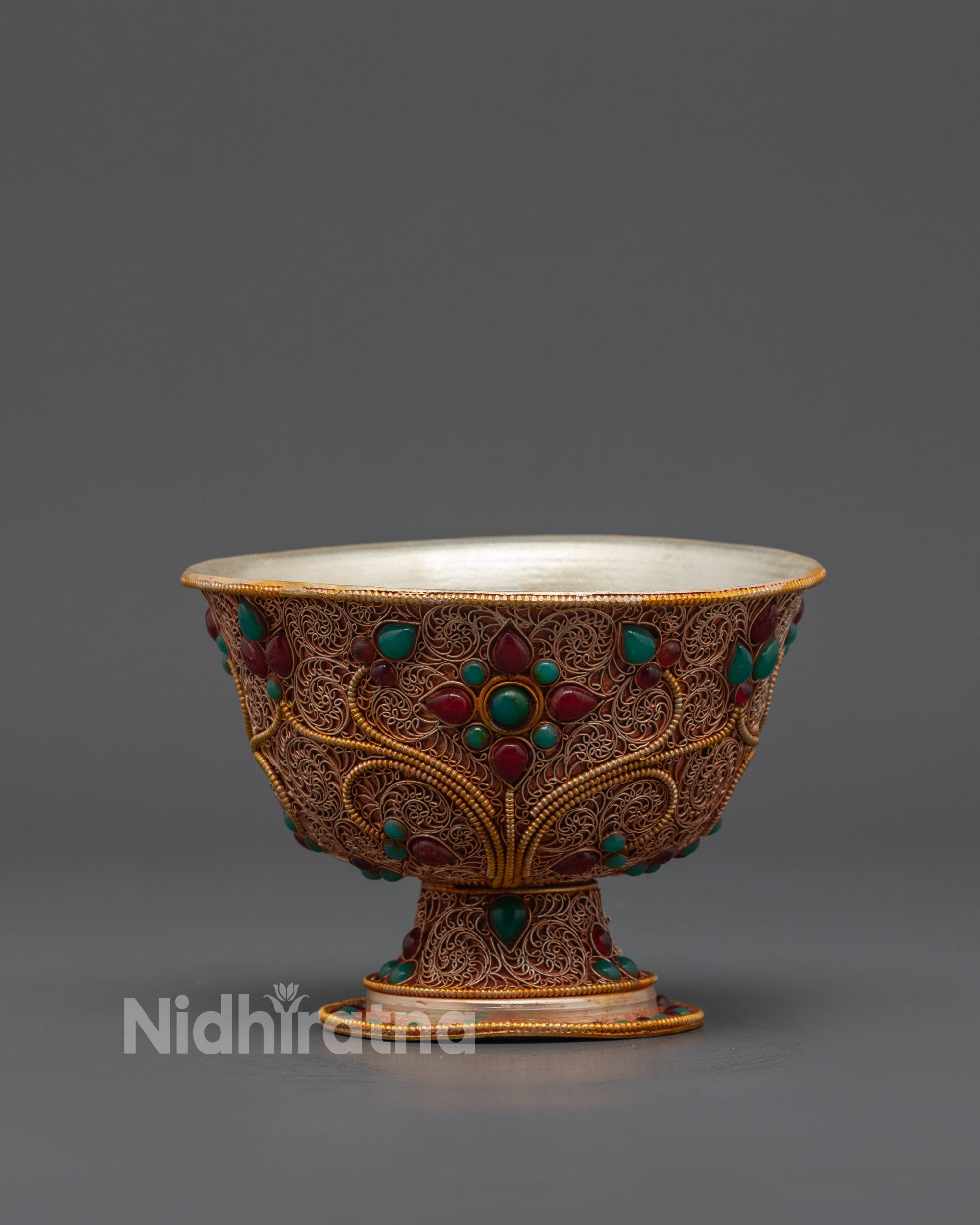 Close up of intricate filigree and semi-precious stones on Tibetan Water Offering Bowl