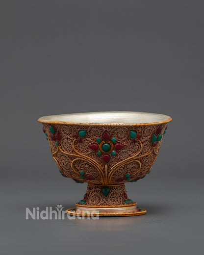 Close up of intricate filigree and semi-precious stones on Tibetan Water Offering Bowl