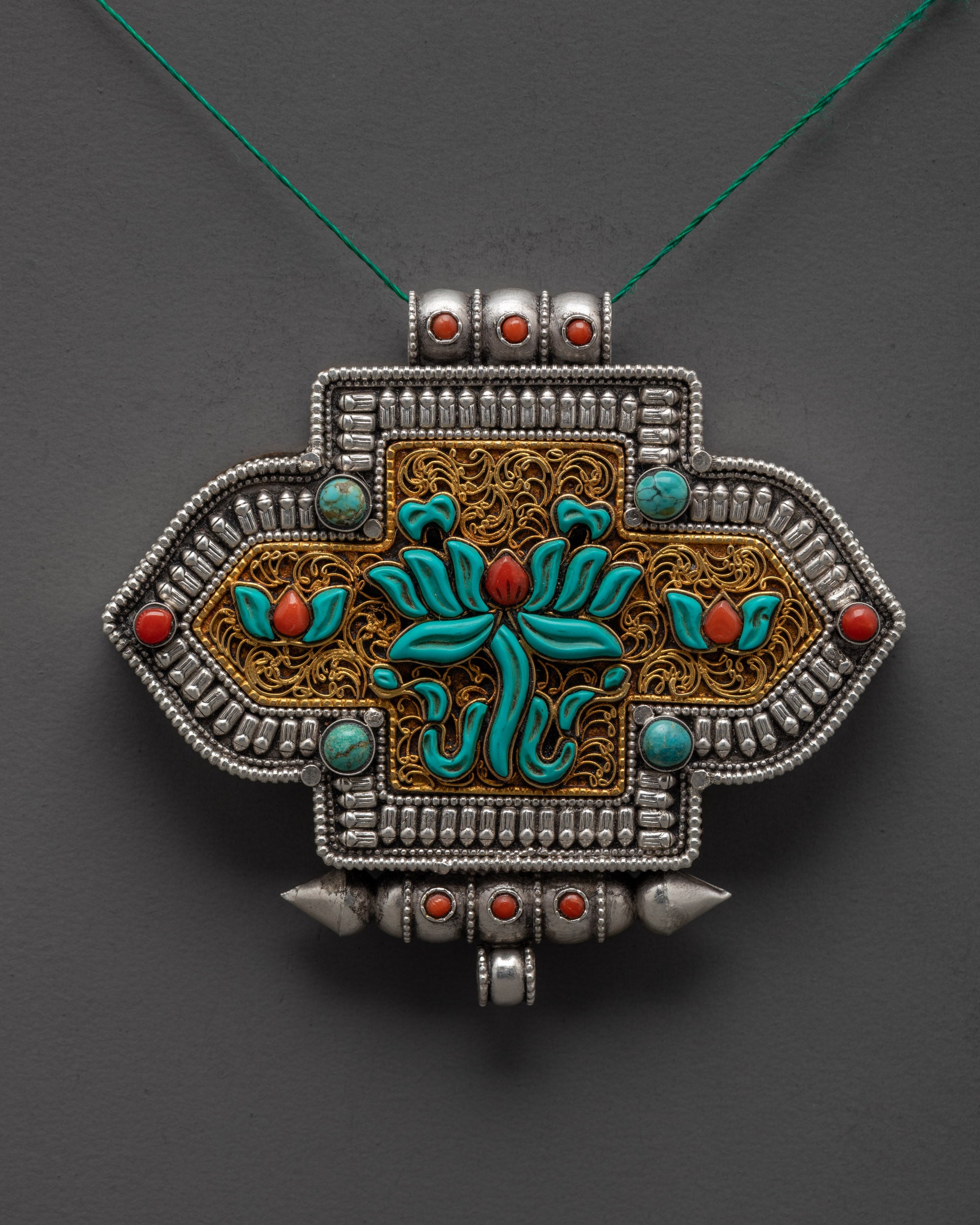 Close up of intricate gold-plated filigree design on Tibetan Lotus Locket pendant