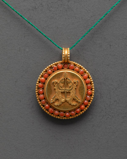 Close up of intricate golden fish carving on gold-plated copper locket from Patan, Nepal