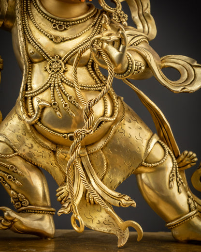 Close up of lasso in Vajrapani statue’s hand gold-gilded
