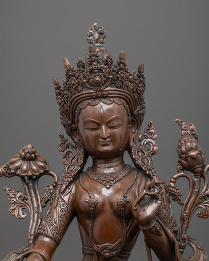 Close up of oxidized copper face and intricate carvings on White Tara meditation statue