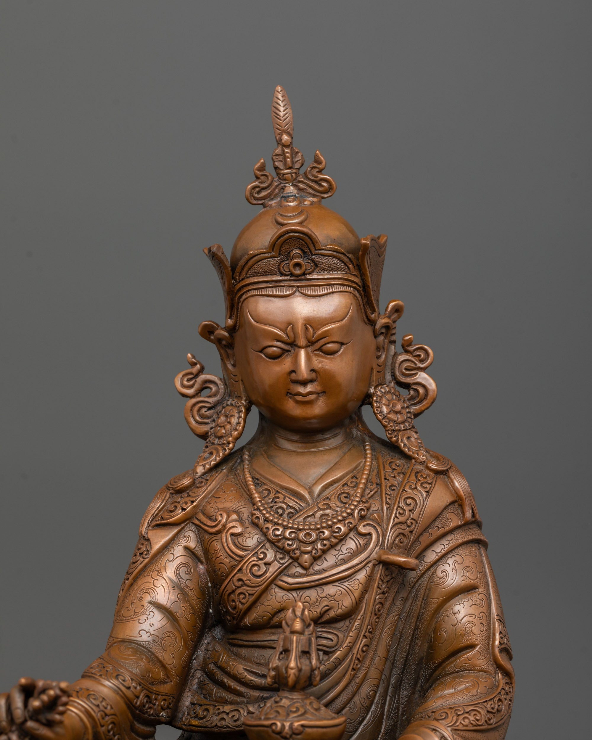 Close up of oxidized copper surface showing brownish hue on Guru Padmasambhava statue