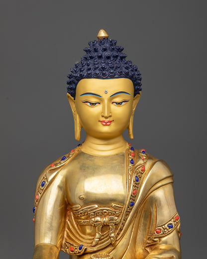 Close up of peaceful face and intricate monk’s robe on Shakyamuni Buddha statue