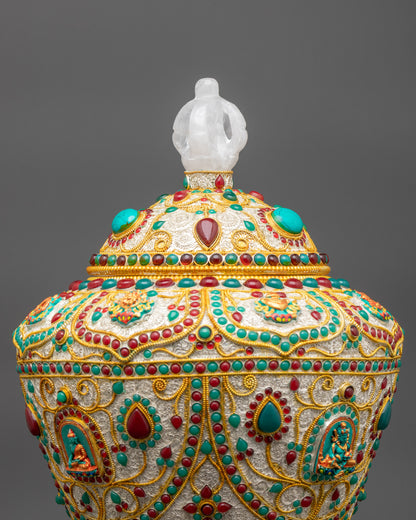 Close up of rice pot showing ruby, turquoise, emerald and engraved Buddhist symbols
