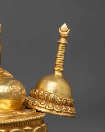 Close up of stupa on Lama Atisa Statue, gold-gilded details highlighting sacred design
