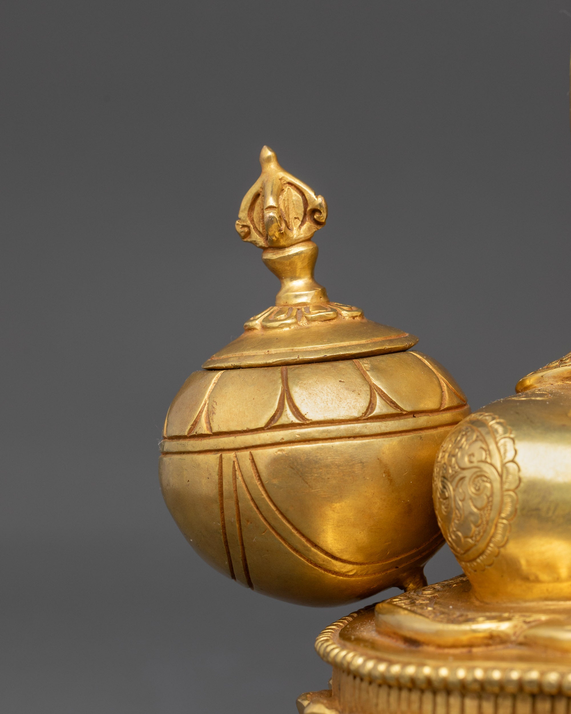 Close up of vase crowned with vajra on Lama Atisa Statue, showcasing spiritual symbols