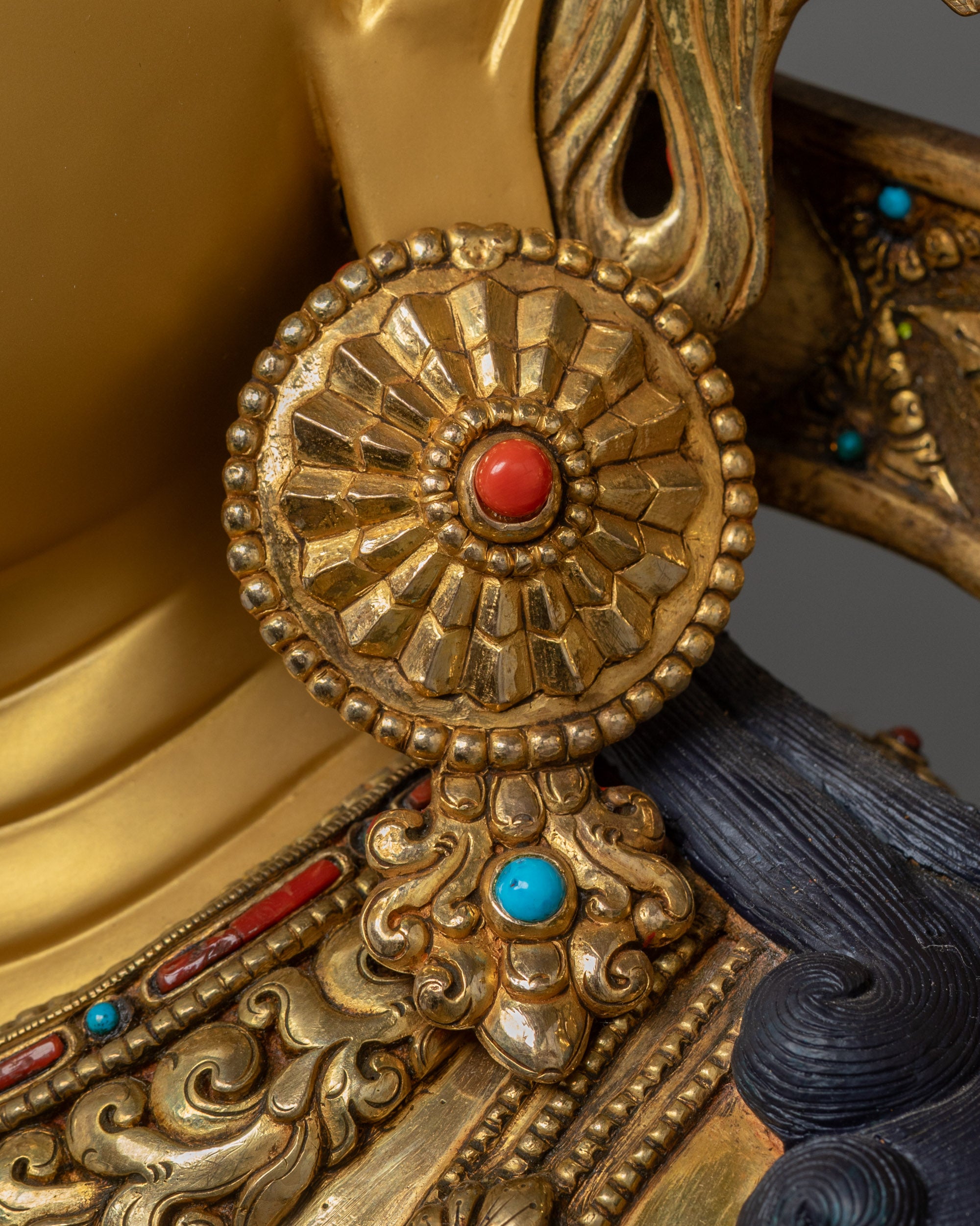 Close up view of jewelry on handcrafted Mother Tara Buddhist sculpture
