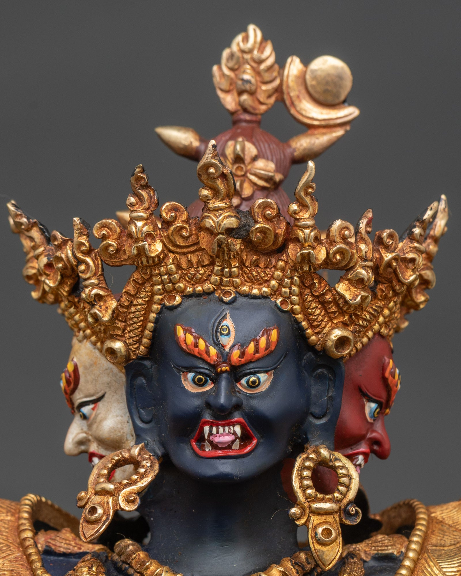 Close view of Chakrasamvara union statue with vajra, bell and gilded ornaments