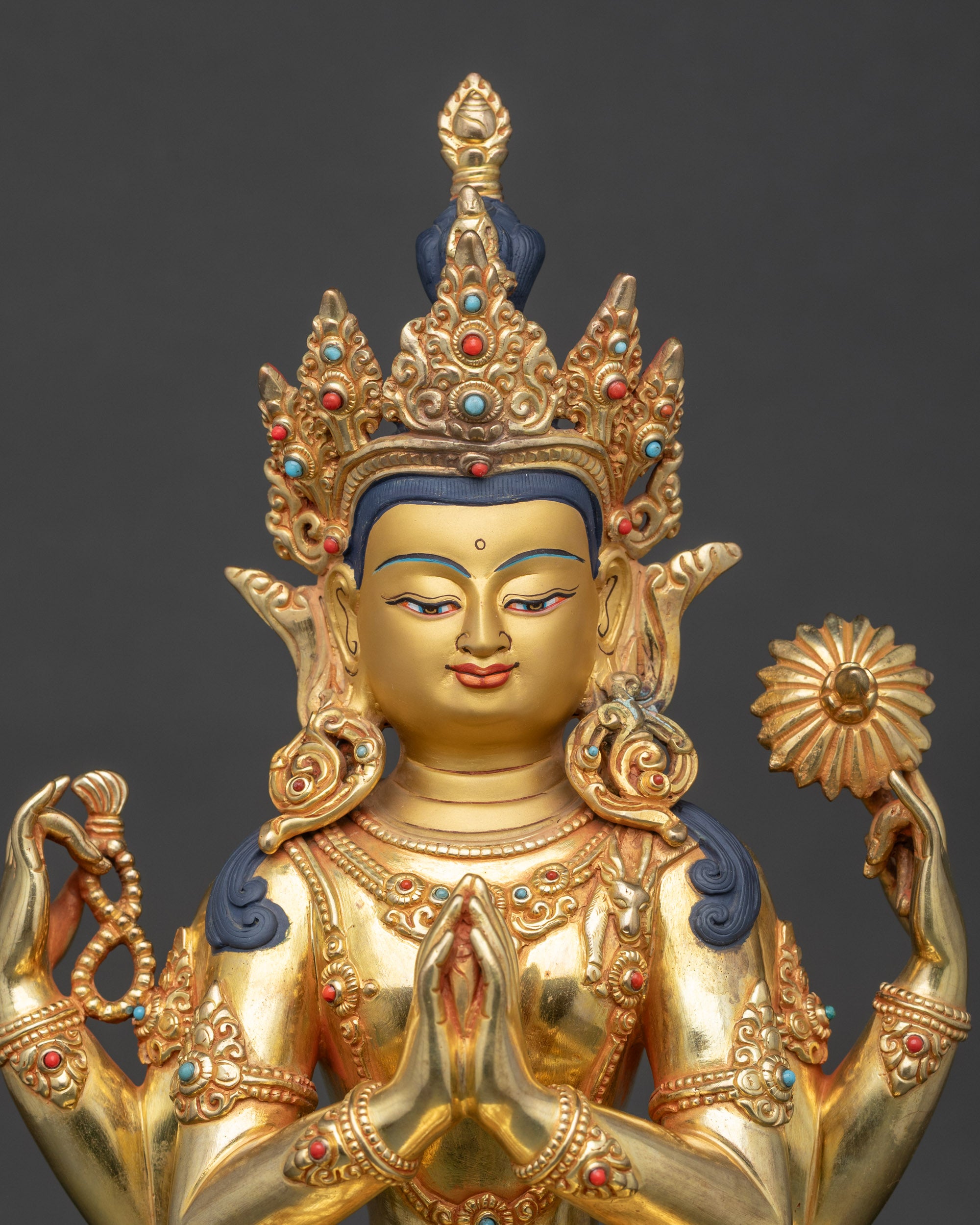 Close view of Chenrezig statue showing intricate carvings and semi-precious stones