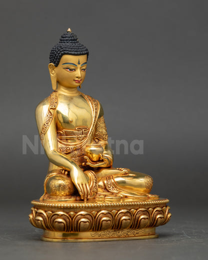 Close view of Shakyamuni Buddha statue highlighting gold fire-gilded face and calm expression
