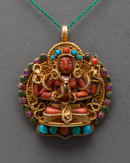 Closeup of Chenrezig Locket details showing red crystal deity, intricate filigree, and gemstone embellishments on a gold-gilded body.