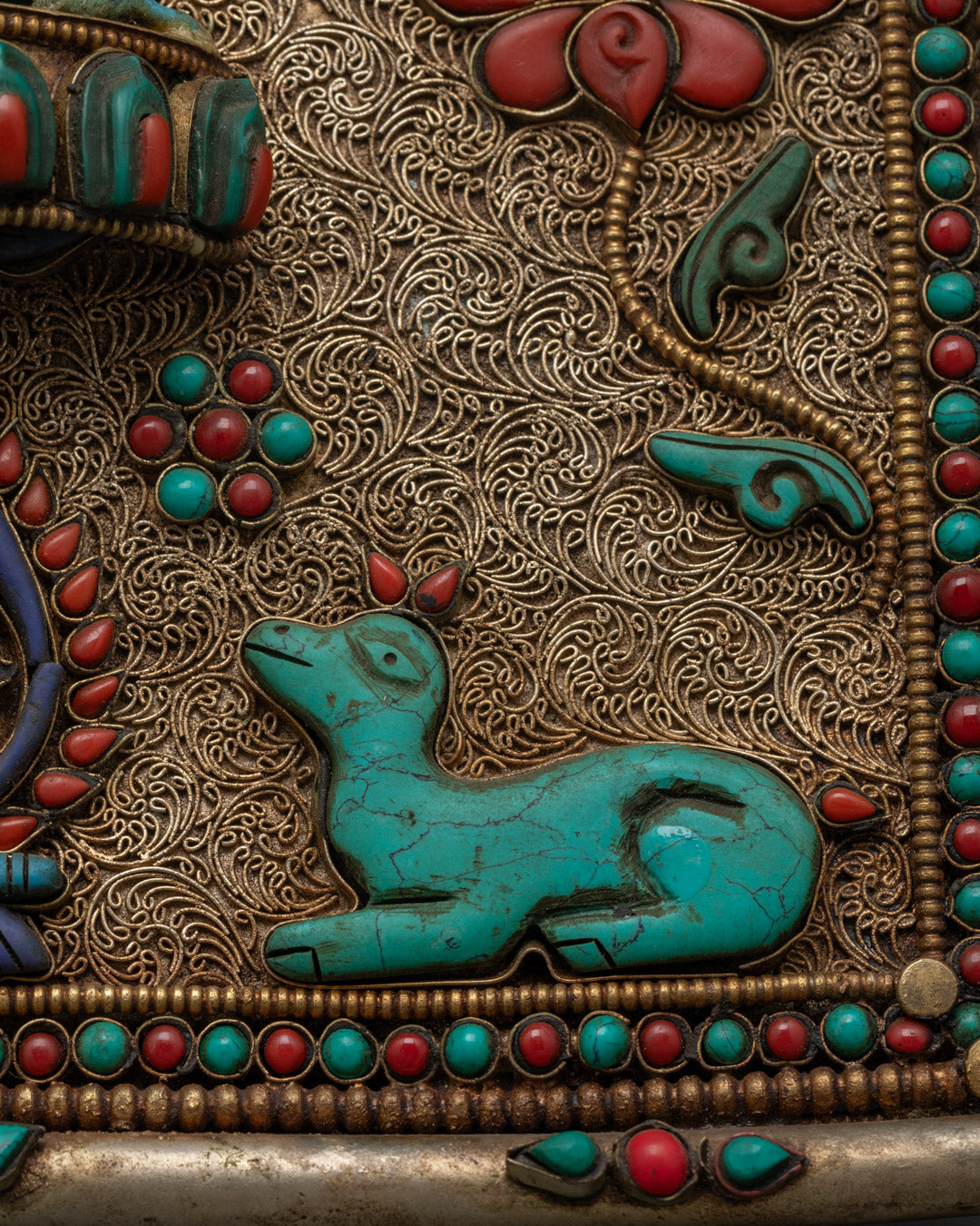 Closeup of Ganesh lotus throne and gemstone details on Dharma wheel wall hanging