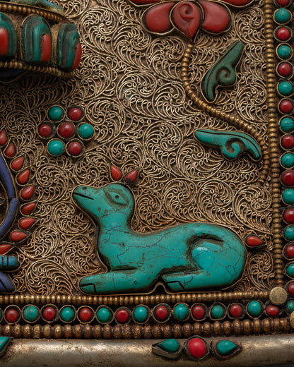 Closeup of Ganesh lotus throne and gemstone details on Dharma wheel wall hanging