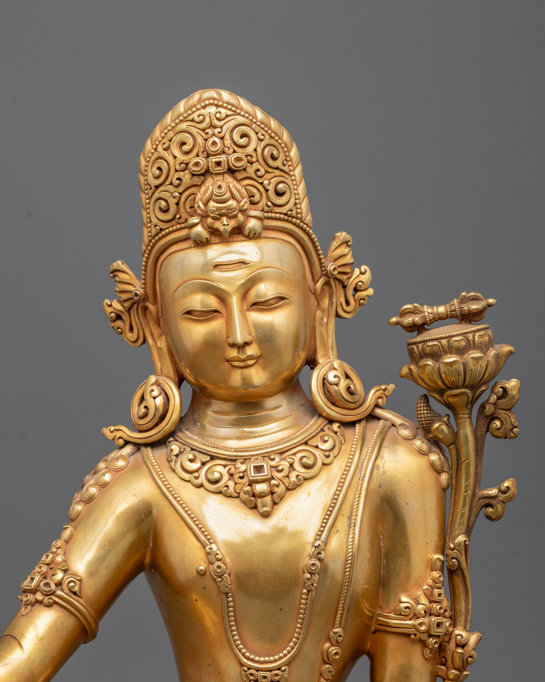 Closeup of Indra Dev’s gold fire-gilded body and detailed jewelry craftsmanship