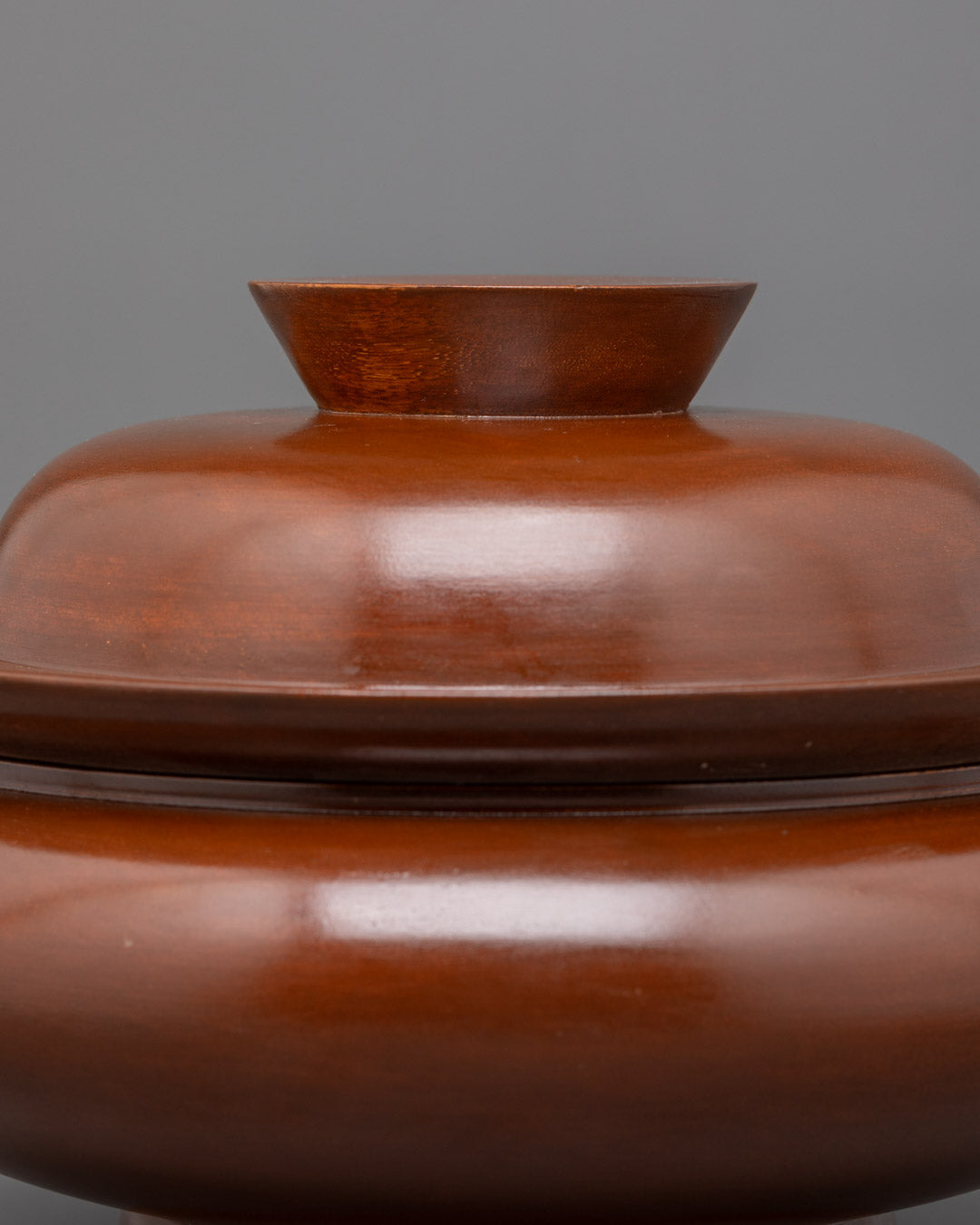 Closeup of intricate wood carving on traditional Tibetan Paru ritual bowl