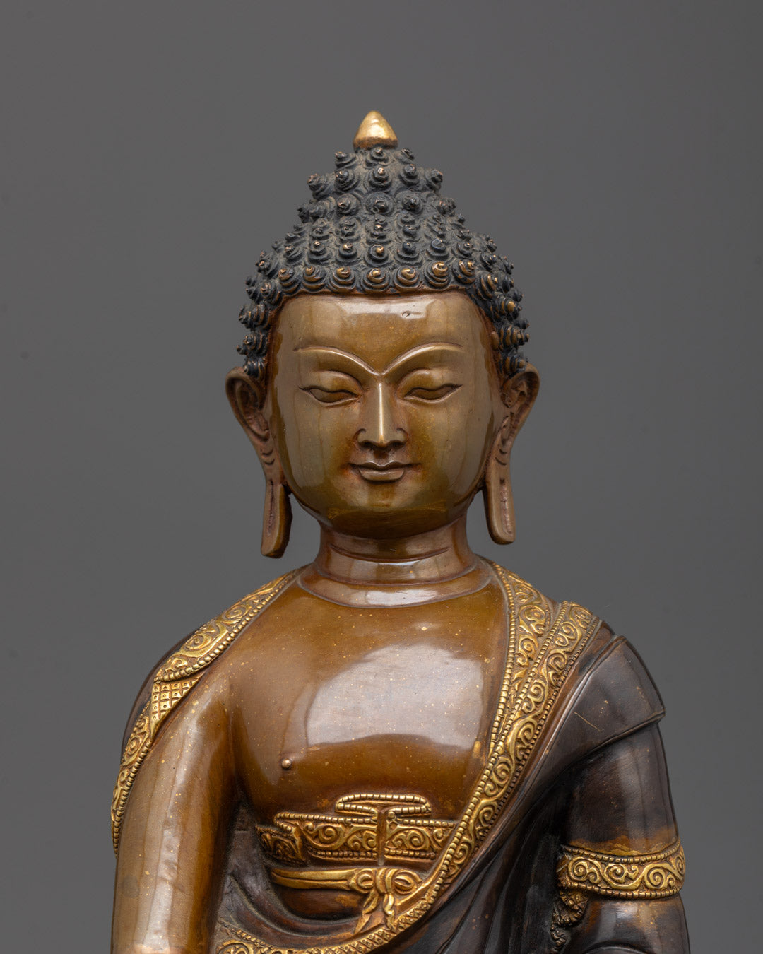 Closeup of oxidized face and patra bowl on Shakyamuni Buddha Tibetan Statue
