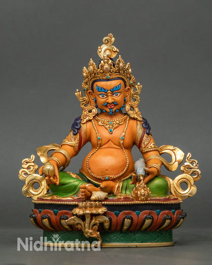 Colorful Dzambhala statue seated on lotus, hand-painted with gold-gilded details