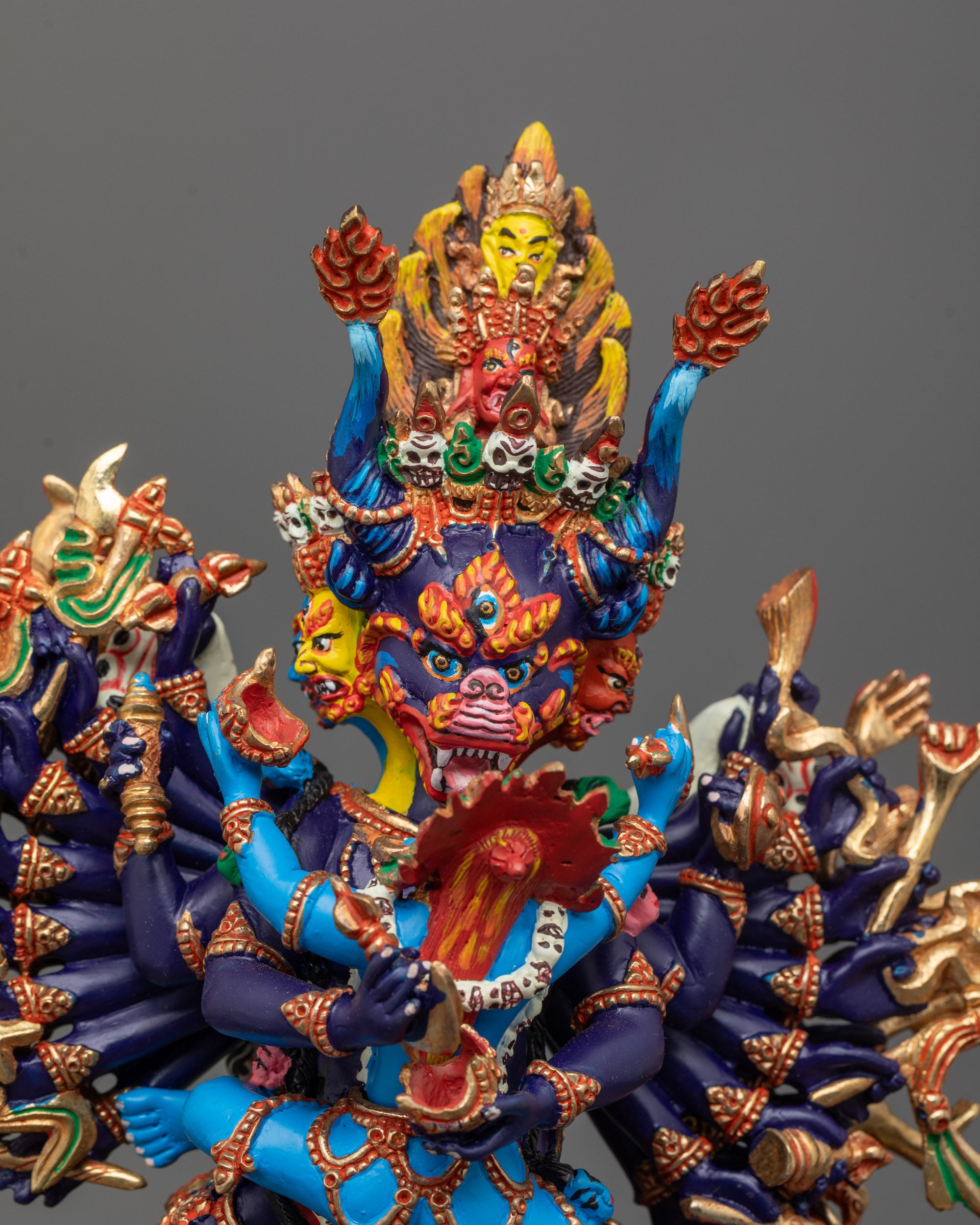 Copper-based Yamantaka Buddhist statue with multiple arms holding symbolic objects