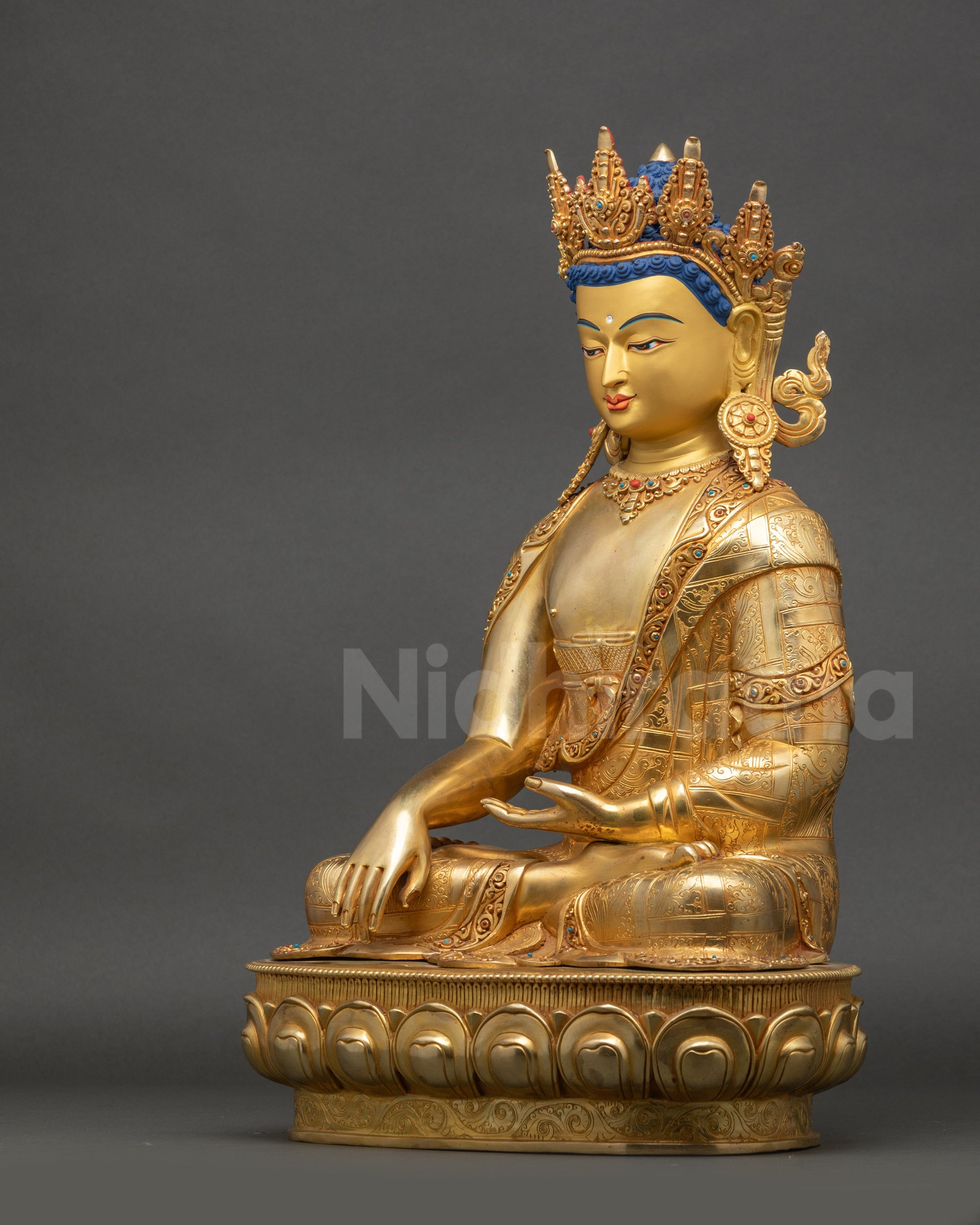 Crowned Shakyamuni Buddha statue displayed on altar with detailed craftsmanship