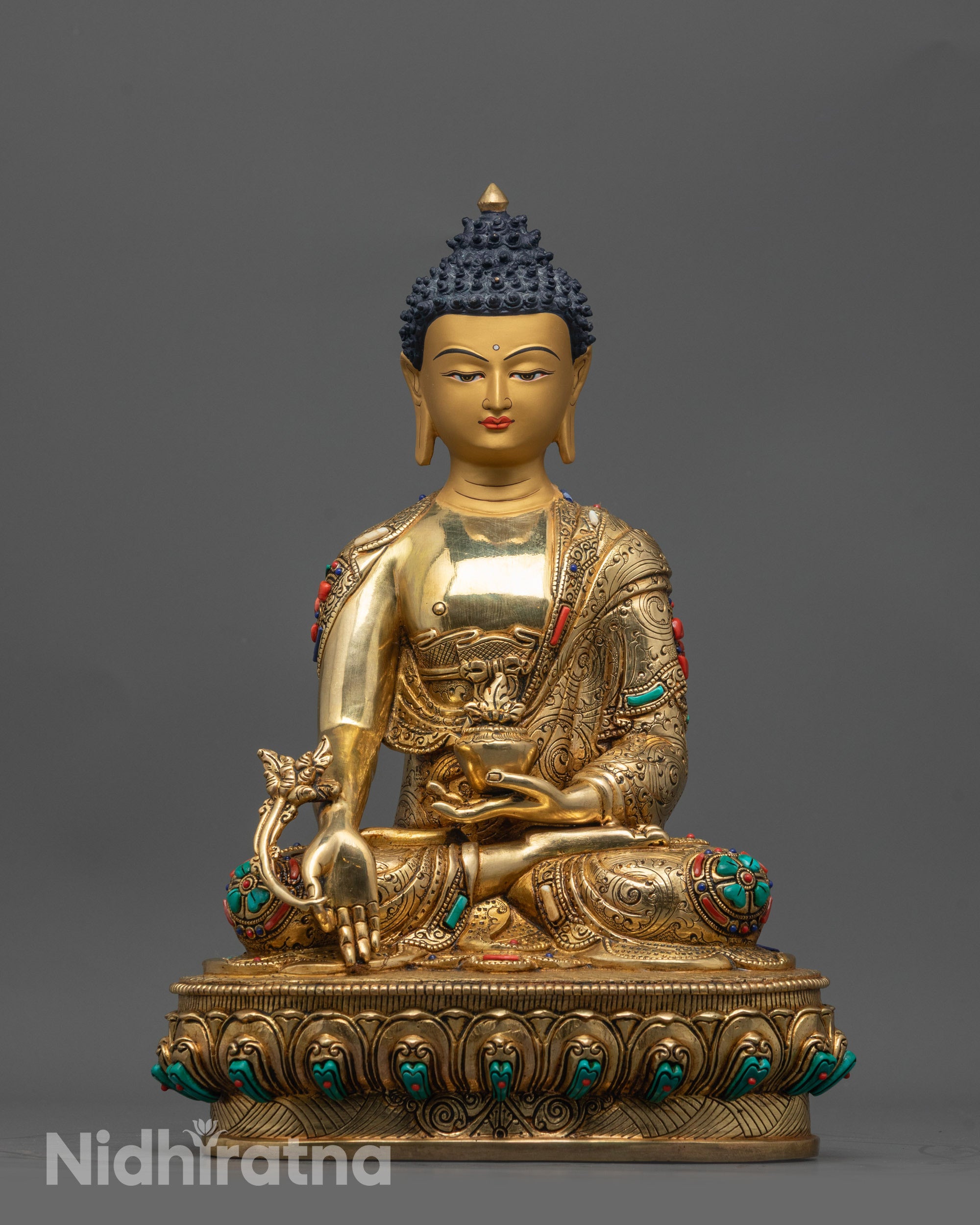 Front view of Medicine Buddha statue with gold-gilded face and polished copper body