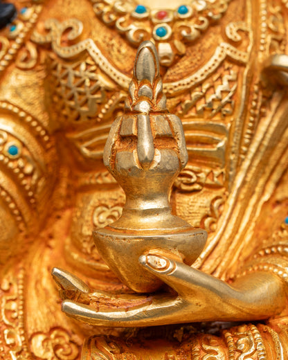 Detail of Guru Rinpoche holding vajra and skull cup, artisan Nepalese copper sculpture