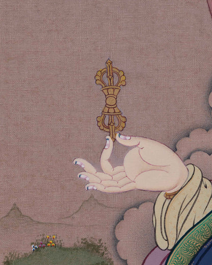Detail of Guru Rinpoche's hands holding the symbolic dorje and tantric khatvanga staff.