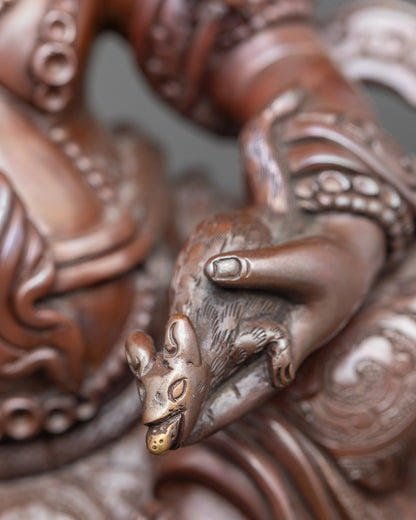 Detail of White Dzambhala holding symbolic mongoose, representing wealth and prosperity
