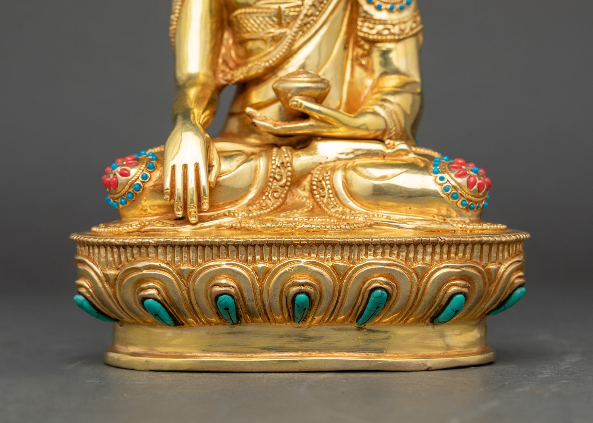 Detail of carved lotus throne with patterned garments, handcrafted Nepalese Buddha