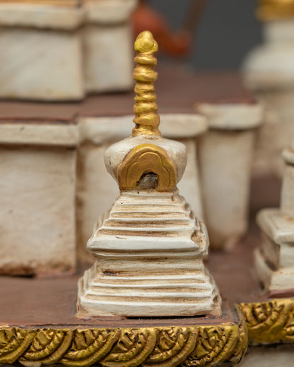 Detailed corner stupa with gold pinnacle on miniature Boudha monument