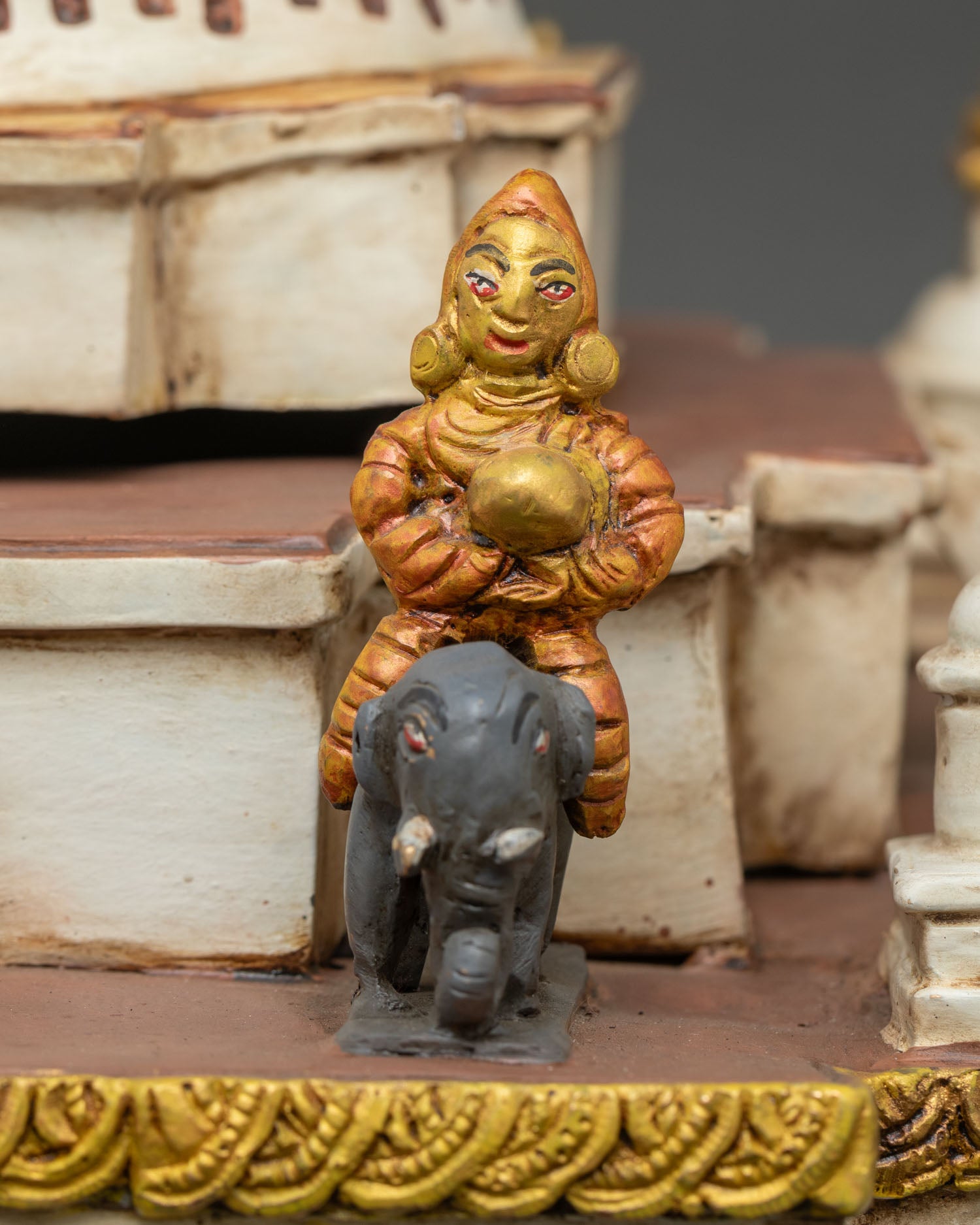 Detailed elephant rider statue on Boudhanath Stupa with symbolic protection