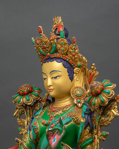 Detailed side close-up of Green Tara statue, copper and gold with ornate crown and robes