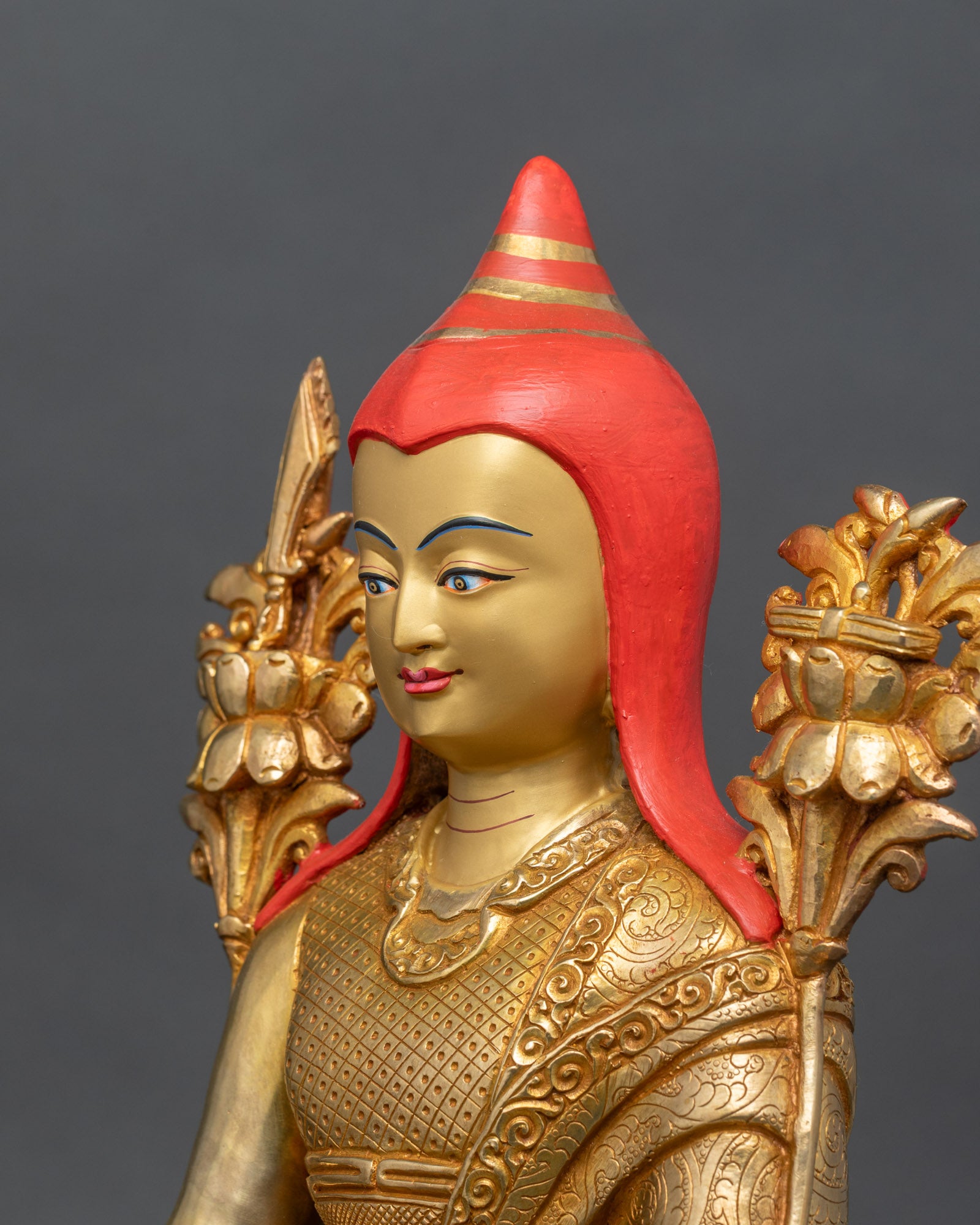 Detailed side close-up of Longchenpa statue, highlighting pandita hat and robe carvings