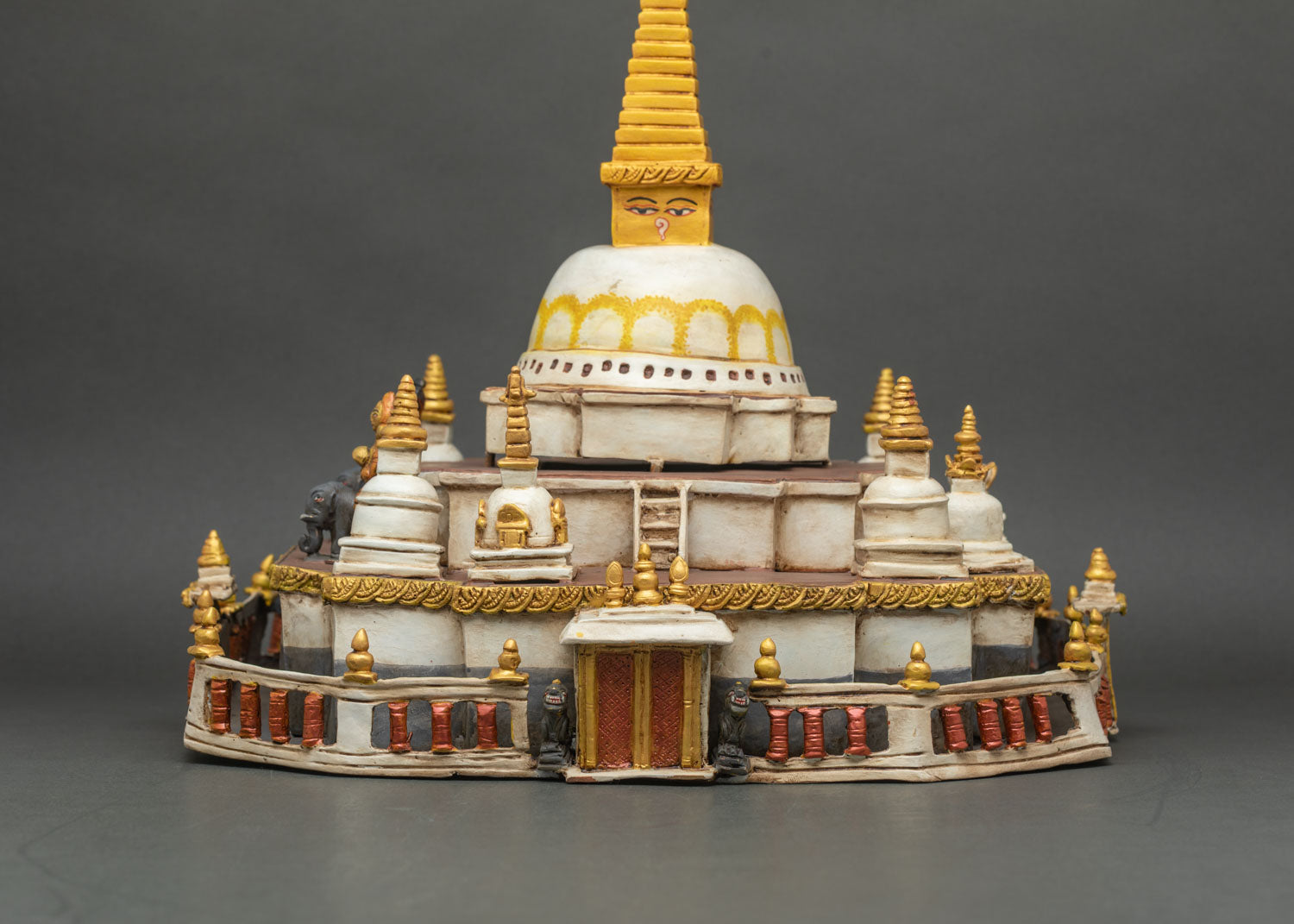 Detailed view of stupa dome with golden pinnacle and hand-painted patterns