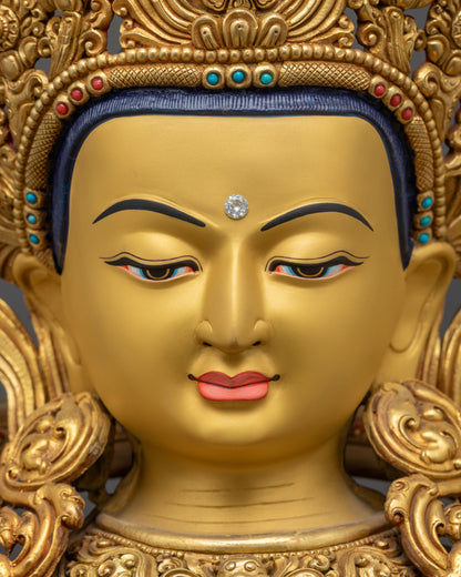 Detailed Close up of Chenrezig Statue face showing serene expression and stone-adorned crown

