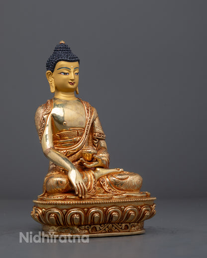 Detailed Shakyamuni Buddha sculpture featuring gold-gilded face and vibrant acrylic colors, symbolizing enlightenment and peace