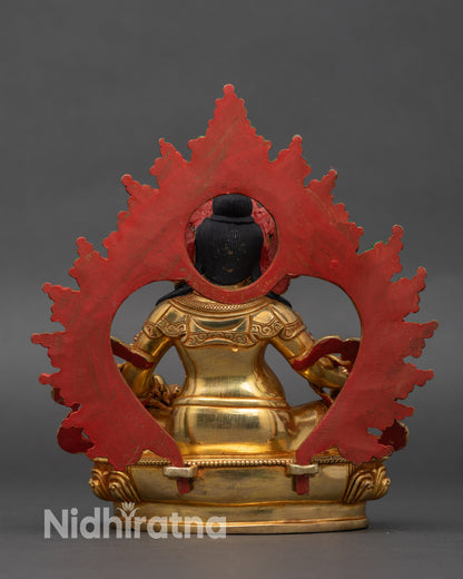 Detailed carvings on garments of Yellow Jambhala, radiant gold fire-gilded base