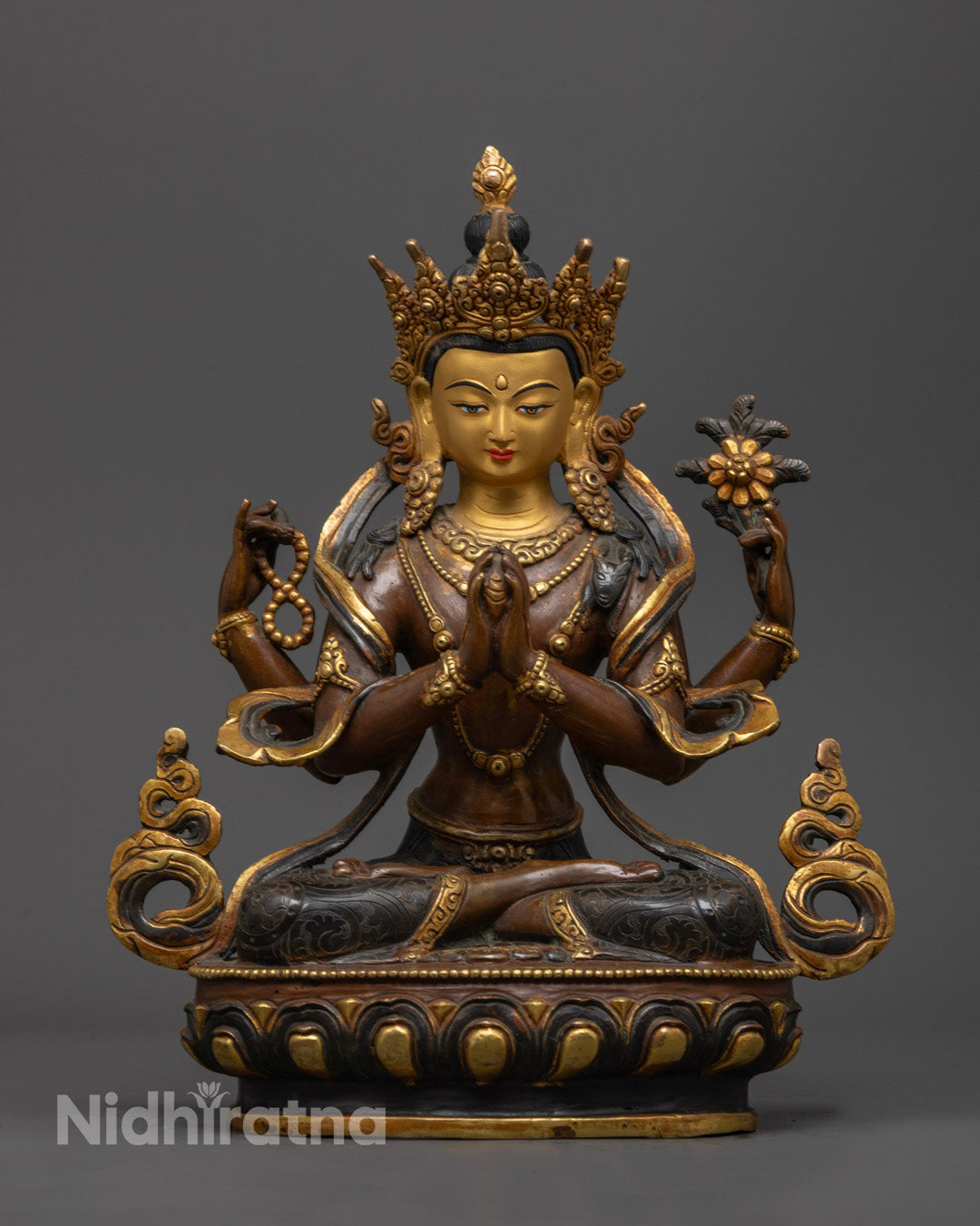 Detailed carvings on the robe and jewelry of the Chenrezig statue are enhanced with vibrant acrylic colors.
