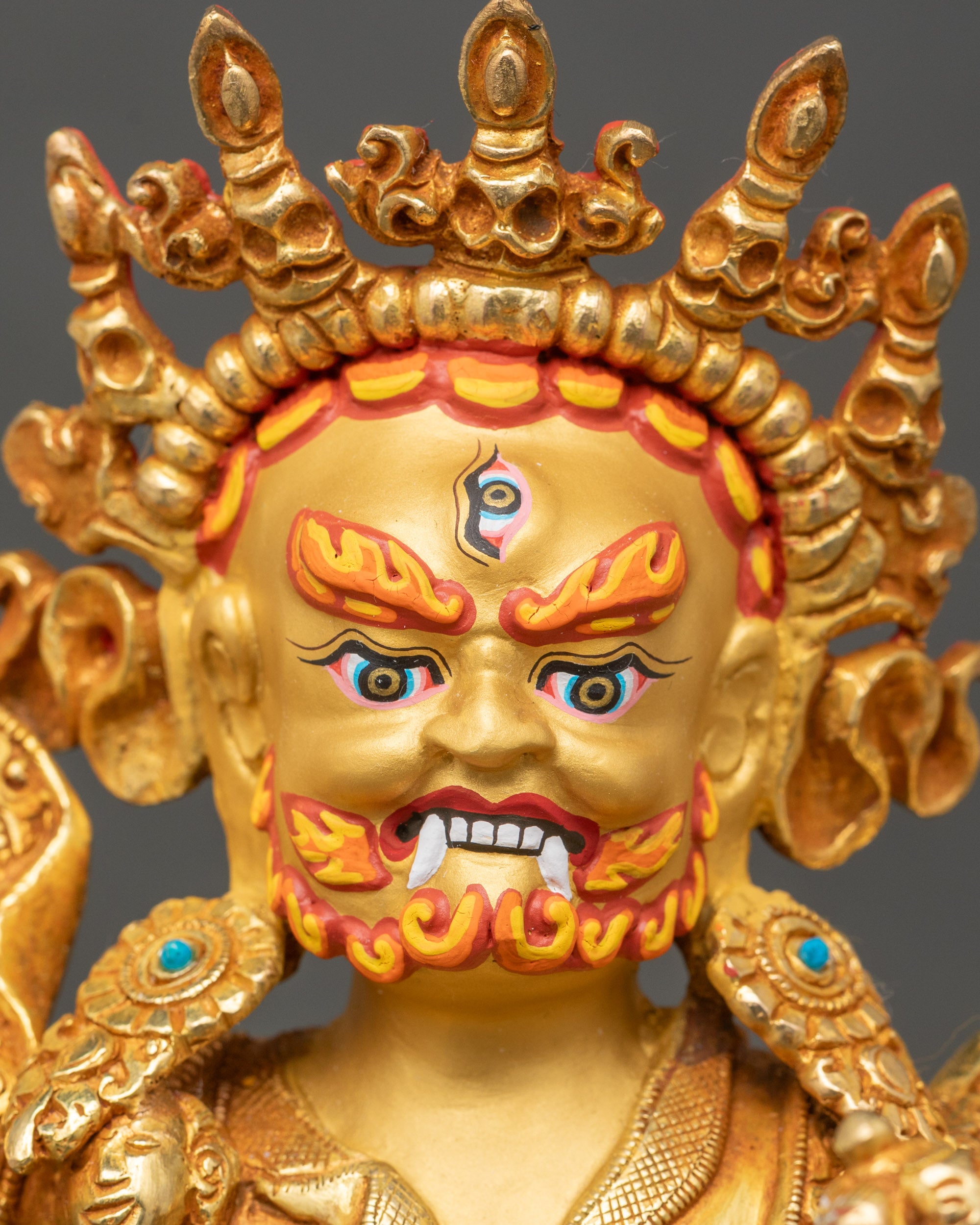 Detailed close-up face – Fierce Dorje Drolo face with third eye, gold fire-gilding, and turquoise inlay