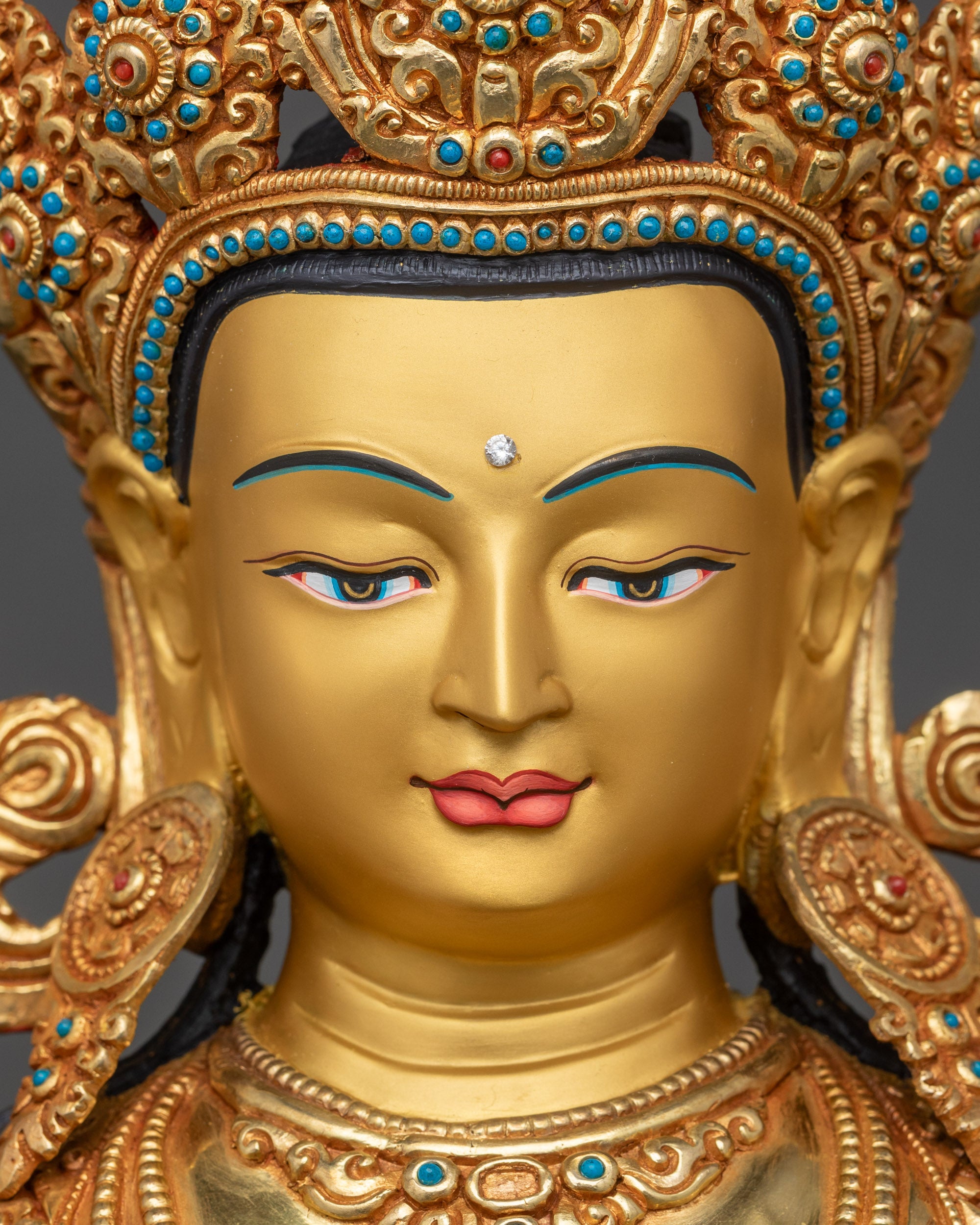 Detailed close-up face of Avalokiteshvara Chenrezig statue with serene compassionate expression