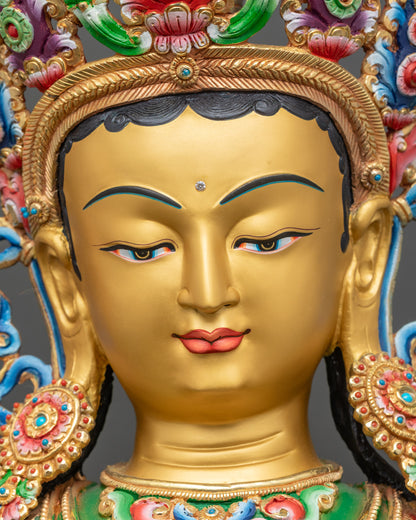 Detailed close-up face of Jetsun Dolma Green Tara with radiant gold-painted expression