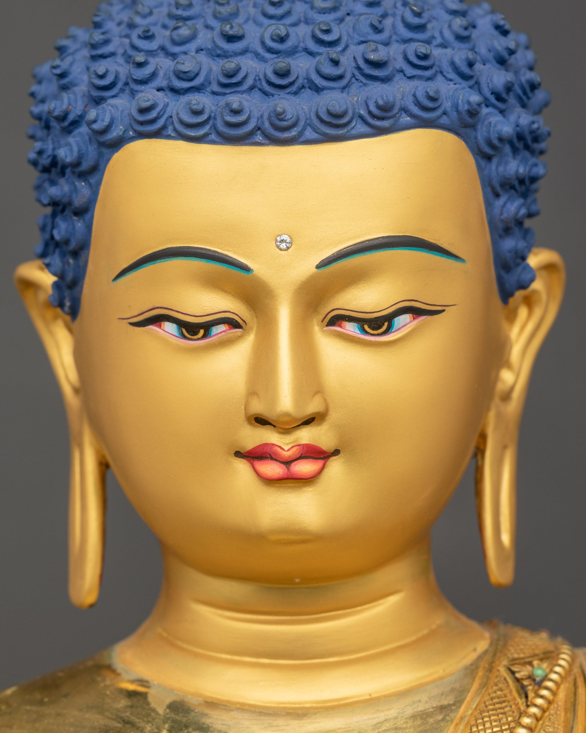Detailed close-up of Buddha’s serene gold-gilded face with peaceful gaze