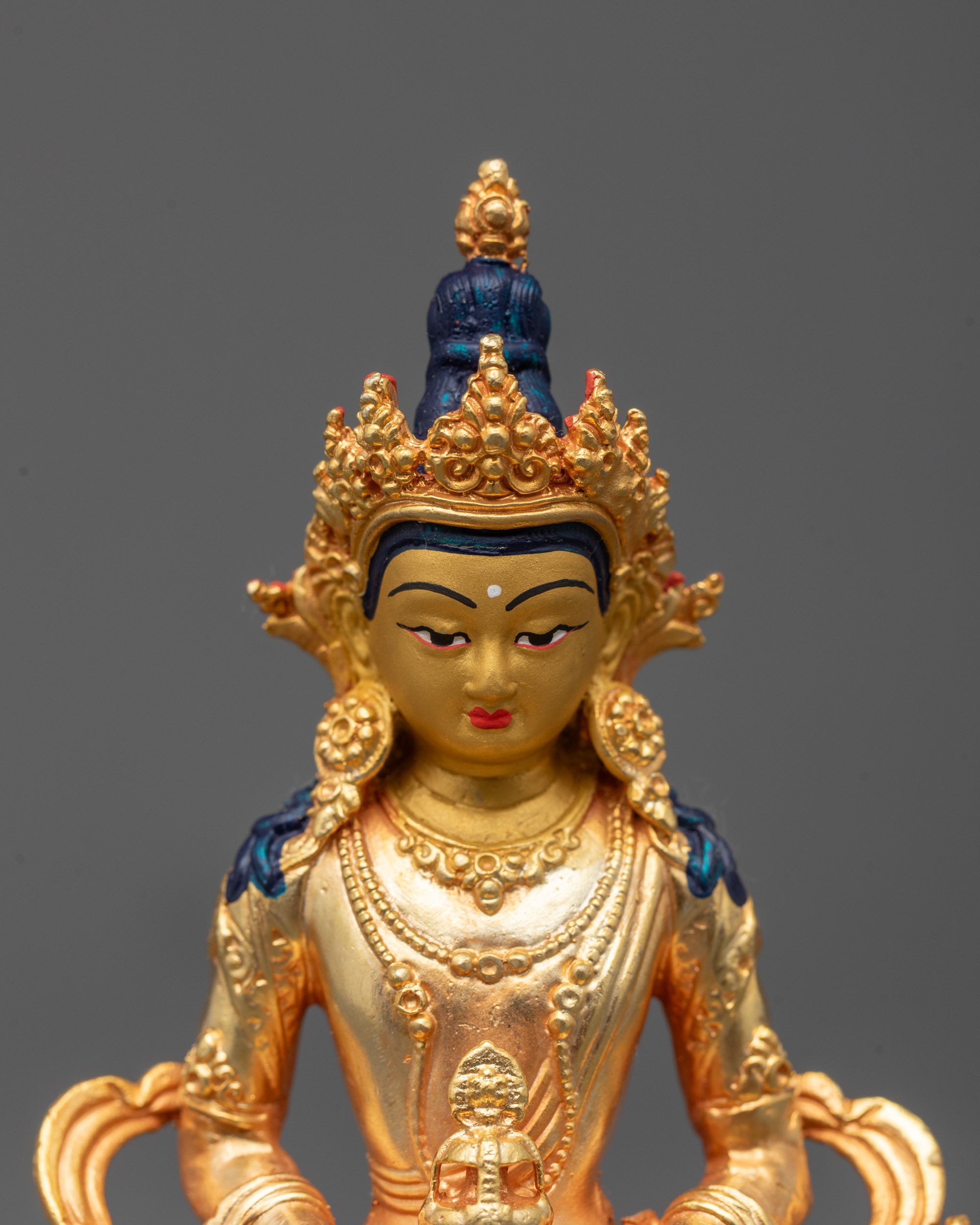 Detailed close-up of Amitayus Buddha statue featuring radiant 24k gold plating
