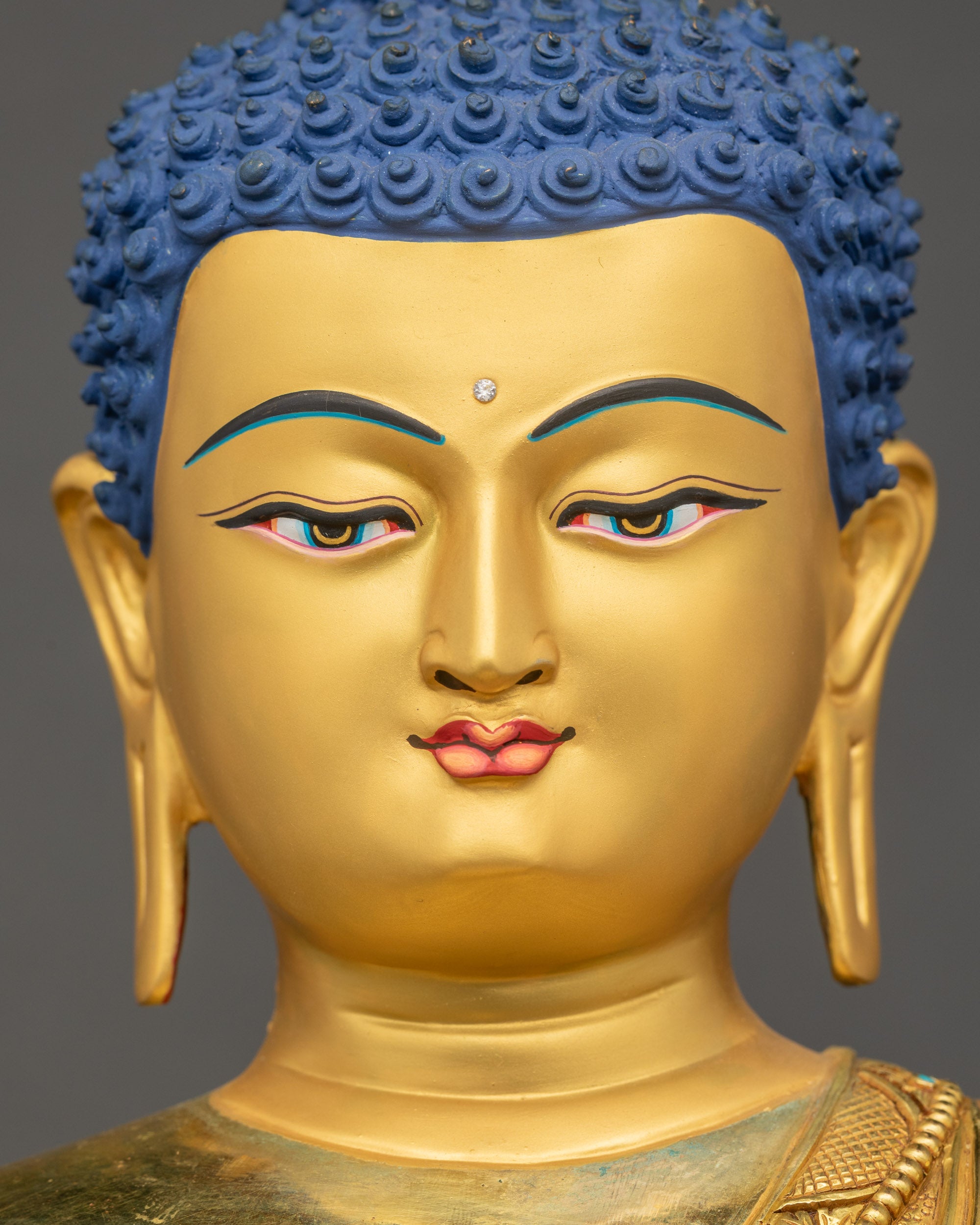 Detailed close-up of Buddha’s calm gold-gilded face with serene expression