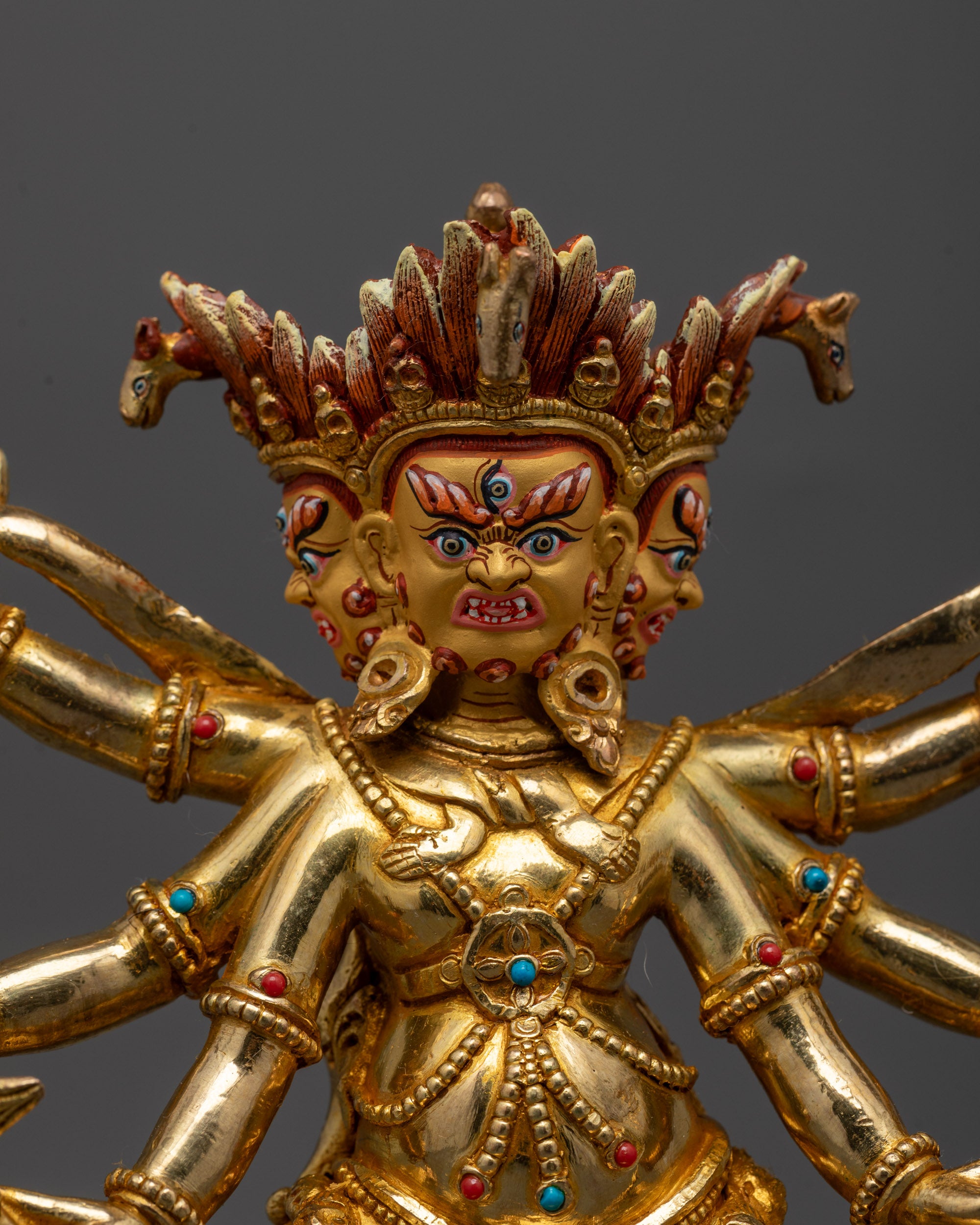 Detailed close-up of Dharmapala Statue showing intricate gold-plated design